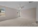 Large and empty primary bedroom featuring neutral carpet, walls and two windows at 302 Flanders Dr, Mooresville, NC 28117