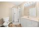 Modern bathroom features a corner shower, white vanity with sink, and tile-look vinyl floors at 304 Valley Brook Se Ln, Concord, NC 28025