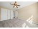 Spacious bedroom with double closets and neutral walls and carpet plus ceiling fan at 304 Valley Brook Se Ln, Concord, NC 28025