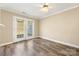 Bright bedroom with wood floors, a ceiling fan, and double doors to the outside at 304 Valley Brook Se Ln, Concord, NC 28025