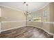 Dining room with a chandelier fixture, windows, and modern flooring at 304 Valley Brook Se Ln, Concord, NC 28025