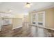 Open-concept kitchen with white cabinetry, modern appliances, and wood floors at 304 Valley Brook Se Ln, Concord, NC 28025