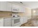 Kitchen featuring white cabinets and appliances at 304 Valley Brook Se Ln, Concord, NC 28025