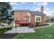 Brick home featuring a large deck, patio, and well-kept lawn at 3101 Colvard Park Way, Charlotte, NC 28269