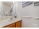 Neutral powder room with white walls, white vanity, and classic wood trim at 3101 Colvard Park Way, Charlotte, NC 28269