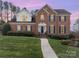 Traditional brick home with manicured lawn, walkway, blue shutters, and a gabled roof on a sunny day at 3101 Colvard Park Way, Charlotte, NC 28269