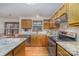 Traditional kitchen with granite countertops, stainless steel appliances, wood cabinets, and hardwood floors at 3101 Colvard Park Way, Charlotte, NC 28269