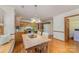 Charming kitchen and breakfast nook featuring wood floors, table with chairs, and wooden cabinets at 3101 Colvard Park Way, Charlotte, NC 28269