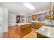 Cozy kitchen featuring an island, granite countertops, stainless steel appliances, wood cabinets, and hardwood floors at 3101 Colvard Park Way, Charlotte, NC 28269