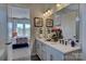 Bright bathroom featuring double vanity with white cabinets and a view to the connected bedroom at 316 Basil Dr, Indian Trail, NC 28079