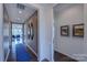 Inviting entryway with wood floors, decorative wall trim, and a view into the living space at 316 Basil Dr, Indian Trail, NC 28079