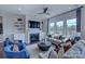 Bright living room with fireplace, built-in shelves, large windows and stylish blue accents at 316 Basil Dr, Indian Trail, NC 28079