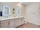 Stylish bathroom with double vanity, illuminated mirrors, modern fixtures, and wood-look flooring at 3630 N Davidson St, Charlotte, NC 28205