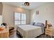 Cozy bedroom features natural light from shuttered windows, light walls, and contemporary ceiling fan at 3630 N Davidson St, Charlotte, NC 28205