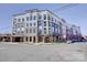 Modern condo building with a combination of brick and siding, as well as beautiful flowering trees at 3630 N Davidson St, Charlotte, NC 28205