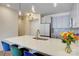 Close up of kitchen island featuring quartz countertops, stainless steel sink, and barstool seating at 3630 N Davidson St, Charlotte, NC 28205