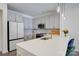 Close up of kitchen featuring stainless steel appliances, gray cabinets, and quartz countertops at 3630 N Davidson St, Charlotte, NC 28205