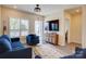 Living room featuring shutters, a television, luxury vinyl plank flooring, and access to balcony at 3630 N Davidson St, Charlotte, NC 28205