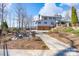 Exterior of home featuring manicured landscaping and a stone patio with fire pit at 368 Fairfield Ct, Mount Gilead, NC 27306