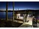 Night view of the private dock featuring a staircase and upper deck overlooking the lake at 368 Fairfield Ct, Mount Gilead, NC 27306