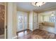 Bright foyer featuring hardwood floors, decorative walls, and an elegant glass front door, welcoming guests at 368 Fairfield Ct, Mount Gilead, NC 27306