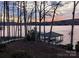 Picturesque sunset view of the lake from the property, featuring a private dock and serene landscape at 368 Fairfield Ct, Mount Gilead, NC 27306