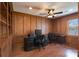 Well-lit office features wood paneling, built in shelving, and a ceiling fan at 368 Fairfield Ct, Mount Gilead, NC 27306