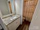 Well-lit bathroom featuring a modern vanity with a granite countertop and a decorative shower curtain at 3726 Windy Pine Nw Ln, Hickory, NC 28601