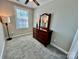 Bright bedroom with plush carpeting, a ceiling fan, and a dresser with a decorative mirror for personal comfort at 3726 Windy Pine Nw Ln, Hickory, NC 28601