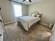 Cozy bedroom featuring plush carpeting, natural light, and a comfortable bed at 3726 Windy Pine Nw Ln, Hickory, NC 28601