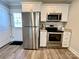 Updated kitchen with stainless steel appliances, white cabinetry, and granite countertops at 3726 Windy Pine Nw Ln, Hickory, NC 28601