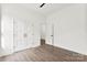 This bedroom features hardwood floors, white walls, and a walk-in closet at 4055 Miller Rd, Salisbury, NC 28147