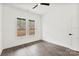 This bedroom features hardwood floors, white walls, and two bright windows at 4055 Miller Rd, Salisbury, NC 28147