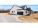 Exterior view of a modern farmhouse-style home with dark-colored garage door and concrete driveway at 4055 Miller Rd, Salisbury, NC 28147