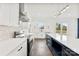 Modern kitchen with stainless steel appliances, white cabinets, quartz countertops, and dark blue island at 4055 Miller Rd, Salisbury, NC 28147