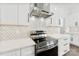 New kitchen features stainless steel range hood, tiled backsplash, quartz countertops, and stainless appliances at 4055 Miller Rd, Salisbury, NC 28147