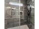 Close-up of a modern glass shower showcasing gray tiling and black shower fixtures at 4055 Miller Rd, Salisbury, NC 28147