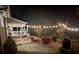 Backyard patio with a cozy seating area, string lights, and manicured plants at 420 Medearis Dr, Charlotte, NC 28211