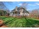 Beautiful backyard with a covered patio, a well-maintained lawn, and mature trees at 420 Medearis Dr, Charlotte, NC 28211