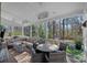 Relaxing covered porch featuring comfortable seating, a ceiling fan, and a view of the serene, wooded backyard at 420 Medearis Dr, Charlotte, NC 28211