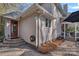 Rear of home with a brick patio and stairs to a red side door at 420 Medearis Dr, Charlotte, NC 28211