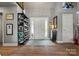 Inviting foyer with hardwood floors, neutral paint, stylish decor, and a white front door with sidelights for natural light at 420 Medearis Dr, Charlotte, NC 28211