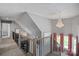 Elegant hallway featuring hardwood railing, chandelier lighting, and artistic decor at 420 Medearis Dr, Charlotte, NC 28211