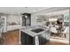 Open kitchen with white cabinets, granite countertops, and gas cooktop island at 420 Medearis Dr, Charlotte, NC 28211