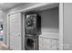 Efficient laundry room featuring stacked washer and dryer with built-in storage and stylish countertop at 420 Medearis Dr, Charlotte, NC 28211