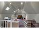 Attic living room featuring multiple skylights and comfortable seating arrangements at 420 Medearis Dr, Charlotte, NC 28211