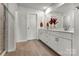 This bathroom features double sinks with modern fixtures, wood look flooring, and a shower, all designed for convenience at 514 Nixon Rd, Belmont, NC 28012