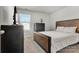 Cozy bedroom features a rustic wood bed frame, neutral walls, and soft carpet at 514 Nixon Rd, Belmont, NC 28012