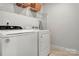 Laundry area equipped with modern washer and dryer units, plus overhead storage shelves at 514 Nixon Rd, Belmont, NC 28012