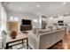 Open-concept living room with hardwood floors, modern furniture, and seamless flow to the kitchen at 514 Nixon Rd, Belmont, NC 28012